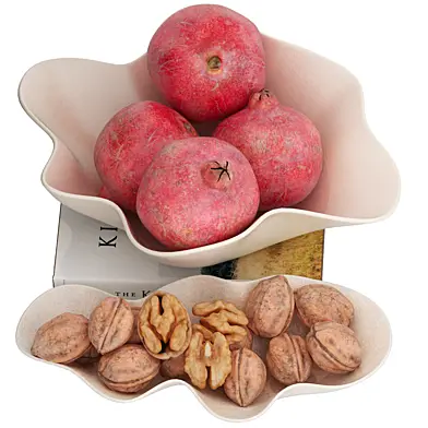 bowl of pomegranates fruit with walnut plate