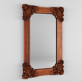 The mirror in the wooden carved frame