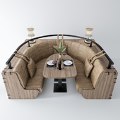 Semicircular sofa with table and decor