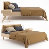 Wooden bed with linen cover