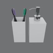 toothbrushes in a glass with a dispenser for liquid soap