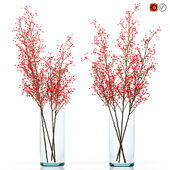 Decorative big branches with red berries in a glass vase