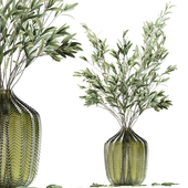 Olive stems in green glass vase