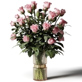 Tall bouquet of pink roses in a modern glass vase