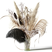 Bouquet of dried flowers with a black feather in a glass vase