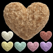 A set of heart-shaped fur pillows