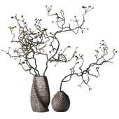 Dry branches with leaves in decorative vases