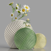 Chamomile branches in leaf-shaped vases