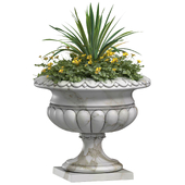 Flowers in a classic vase for facade decoration .Planter.Yellow Flowers in container pot for facade decoration