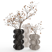 Dry branches in vases with spheres.
