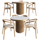 Isaure round metal table and Korento wooden armchair