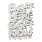 Three-dimensional inscription "Right Here Right Now" on the wall