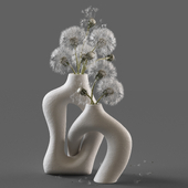 Gray dandelions in a ceramic vase