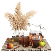 Set with apples, juice and a bouquet of dried flowers